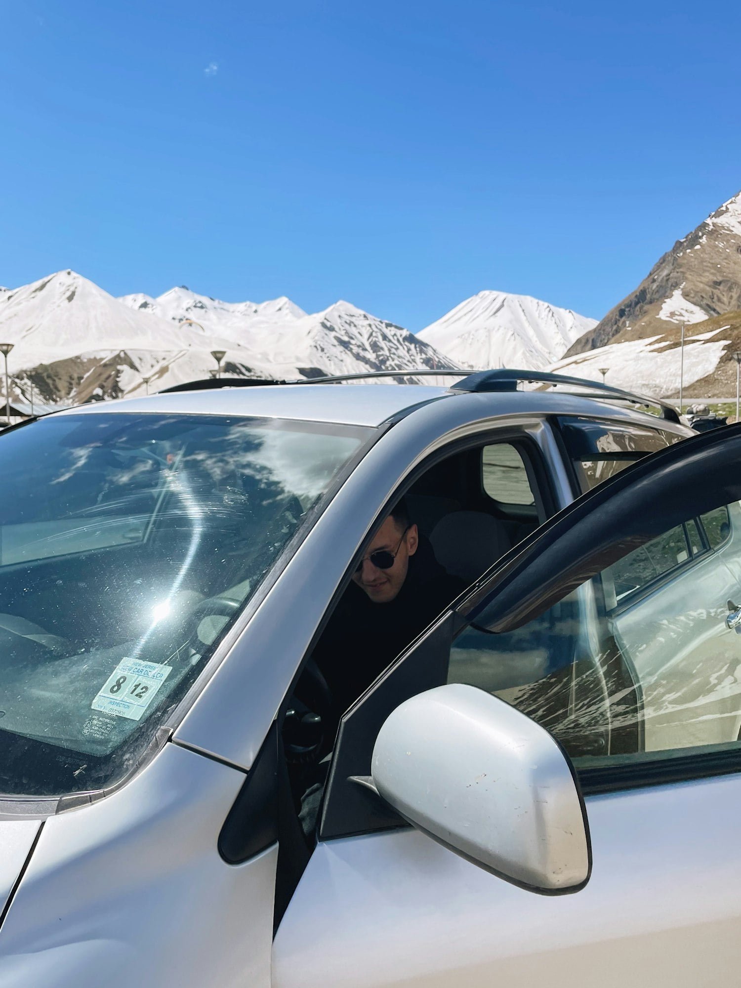 A man driving and riding in car. Experience of driving. Riding in car on the mountains background.