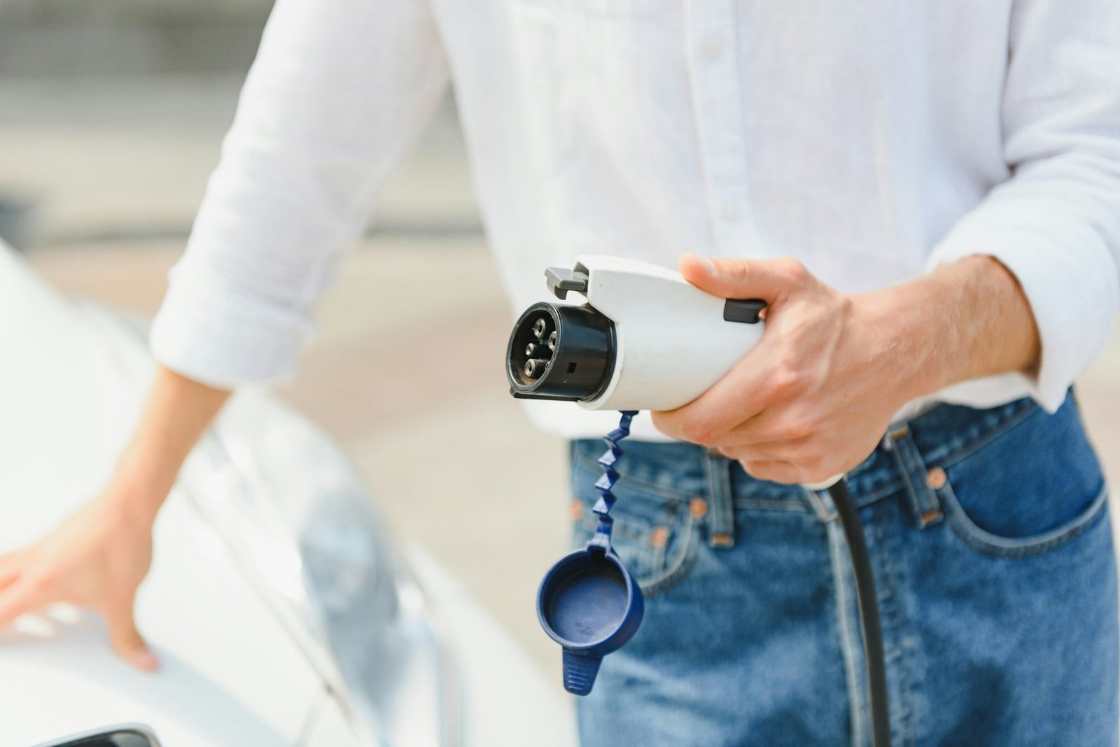 Businessman charging an electric vehicle