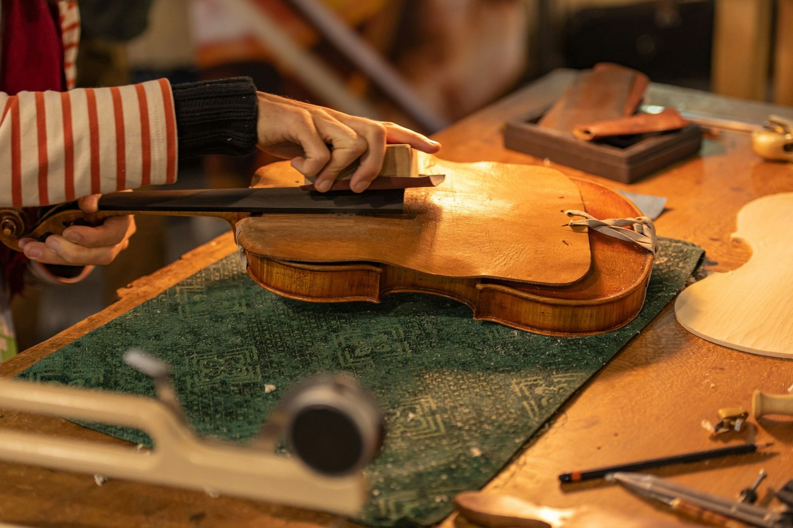 Close-up of a professional master artisan luthier working on the creation of a handmade violin