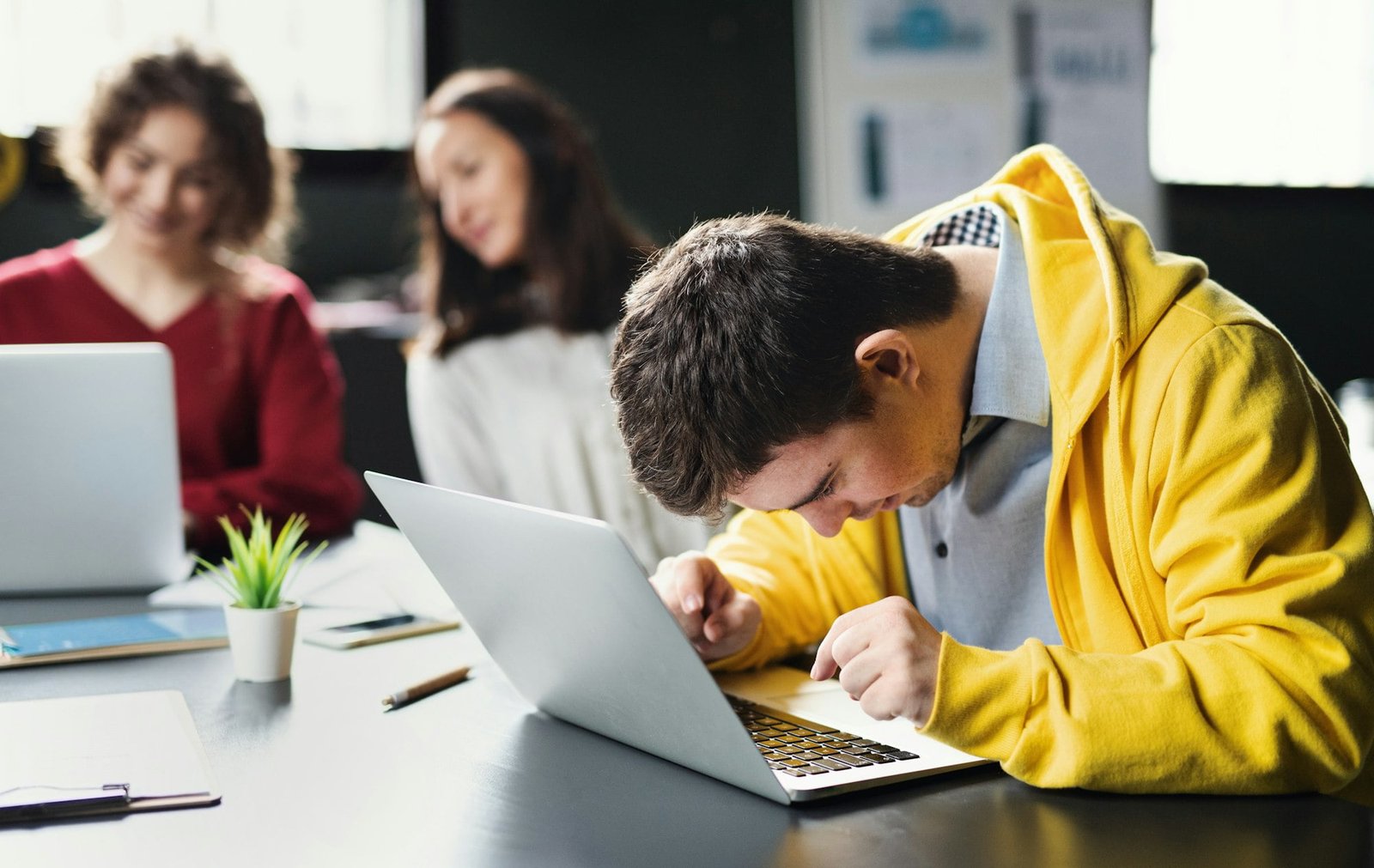 Down-syndrome man with laptop attending education, inclusivity of disabled person.