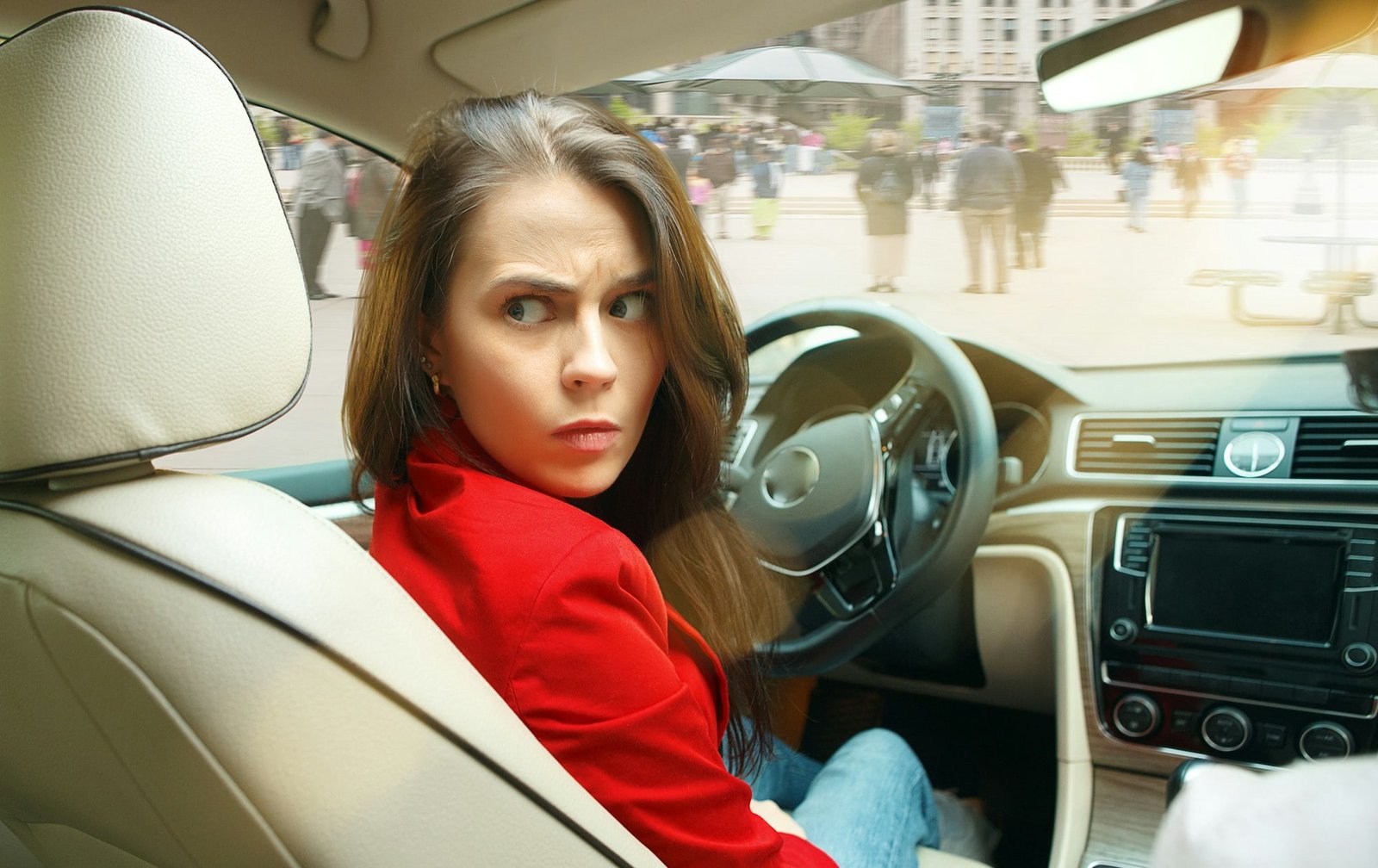 Driving around city. Young attractive woman driving a car