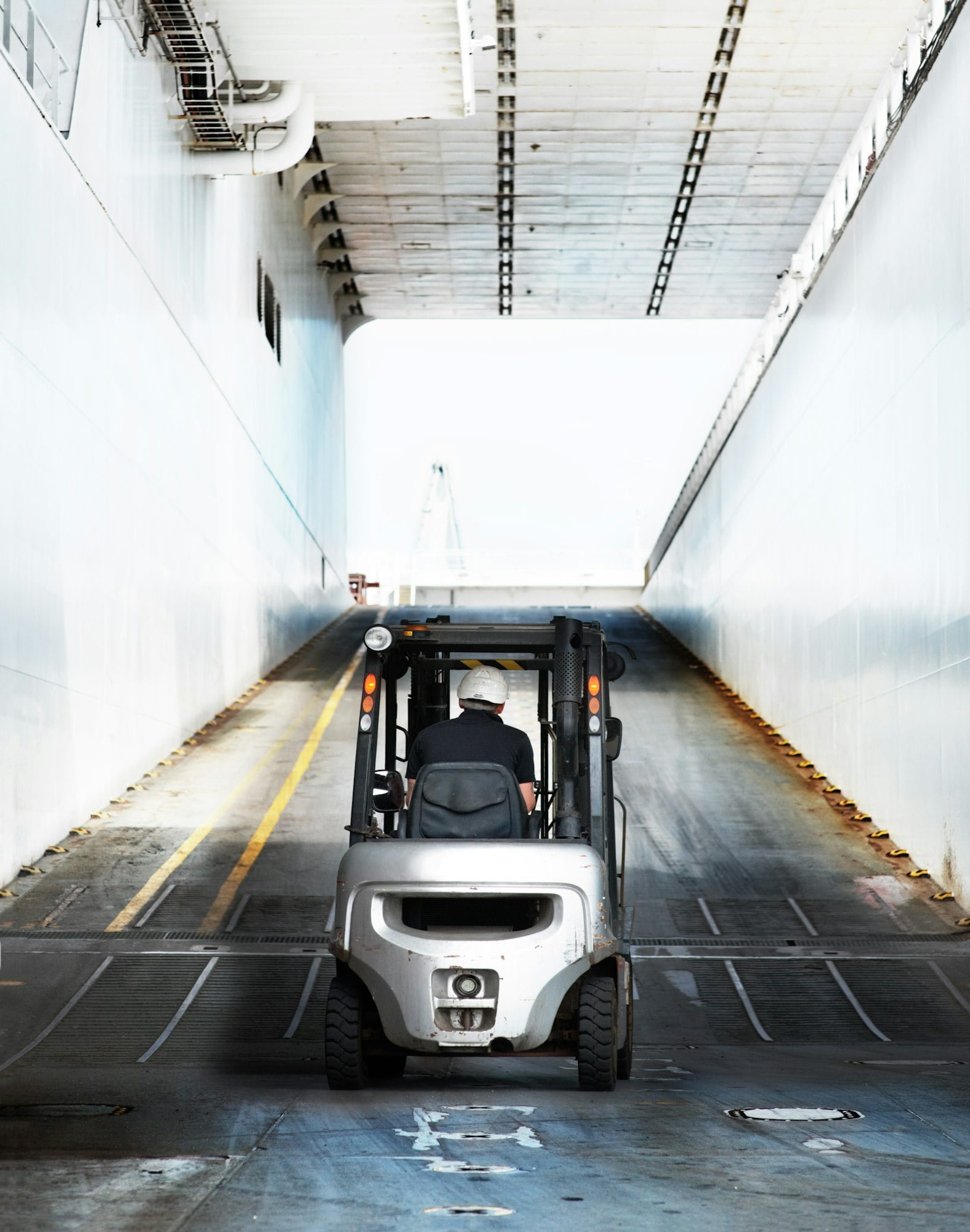 Driving towards the light. A worker driving a vehicle up the ramp.