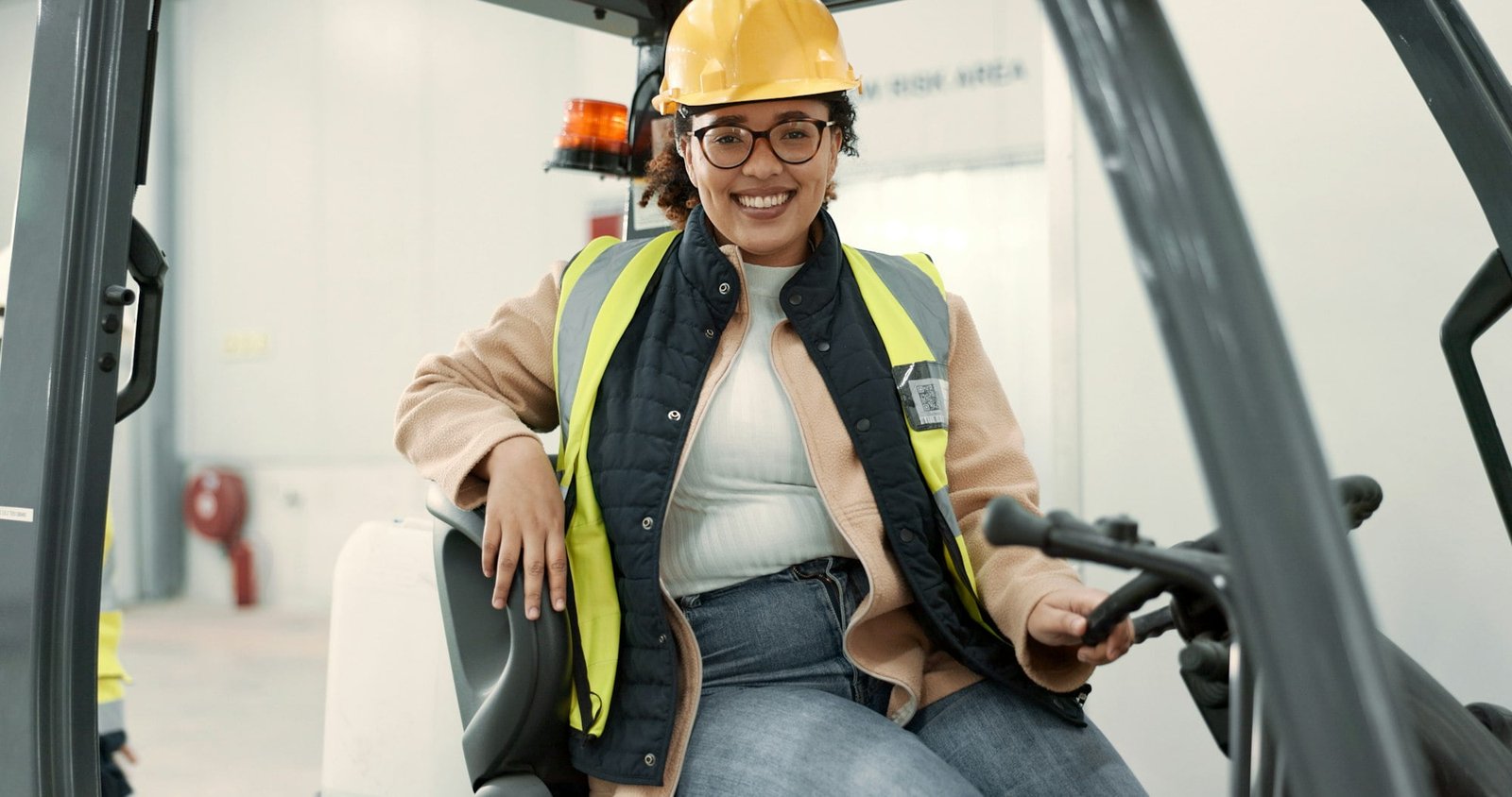 Engineer woman, forklift and smile in portrait for logistics, supply chain or working in warehouse.