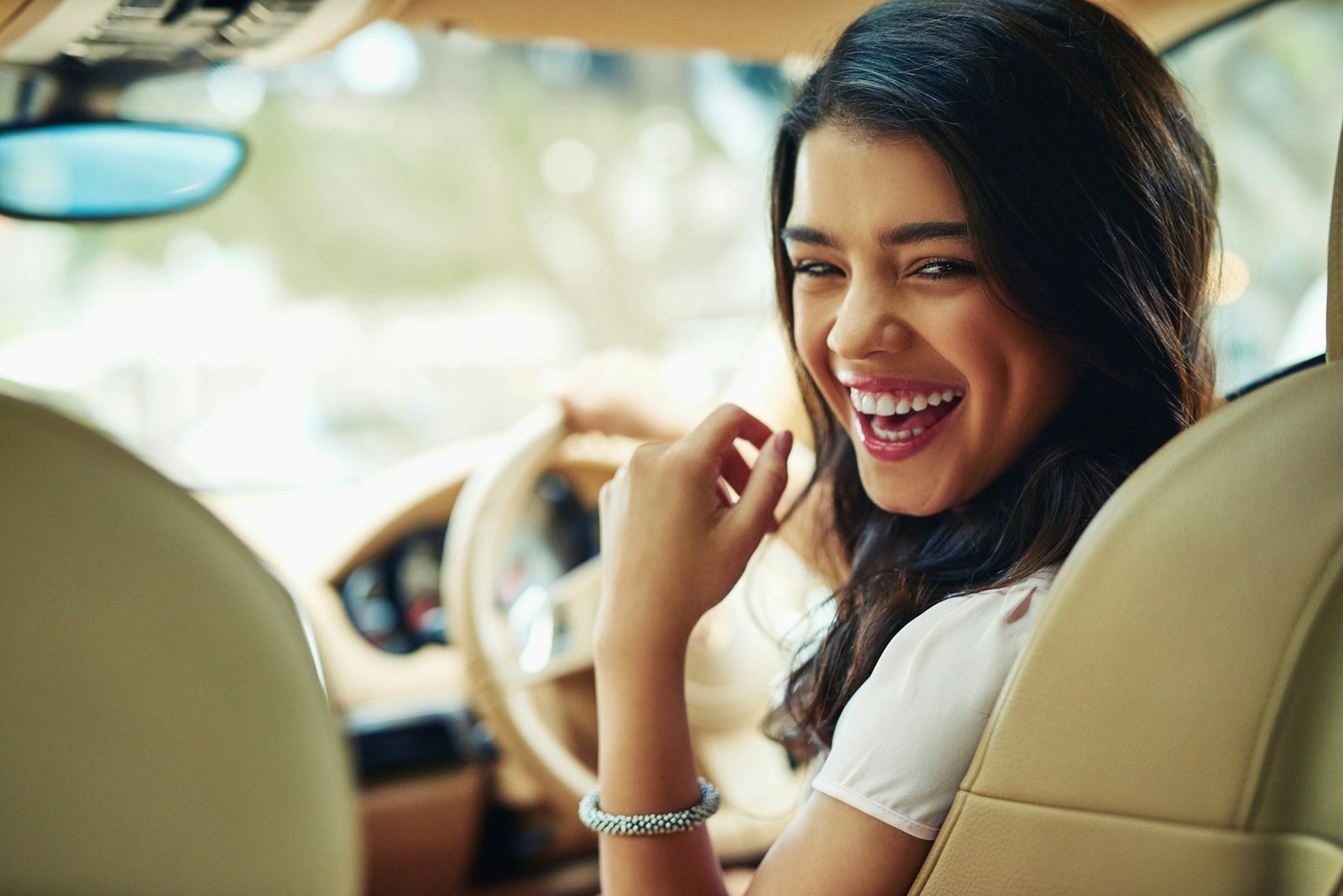 Enjoying her new car. Shot of an attractive young woman driving a car.