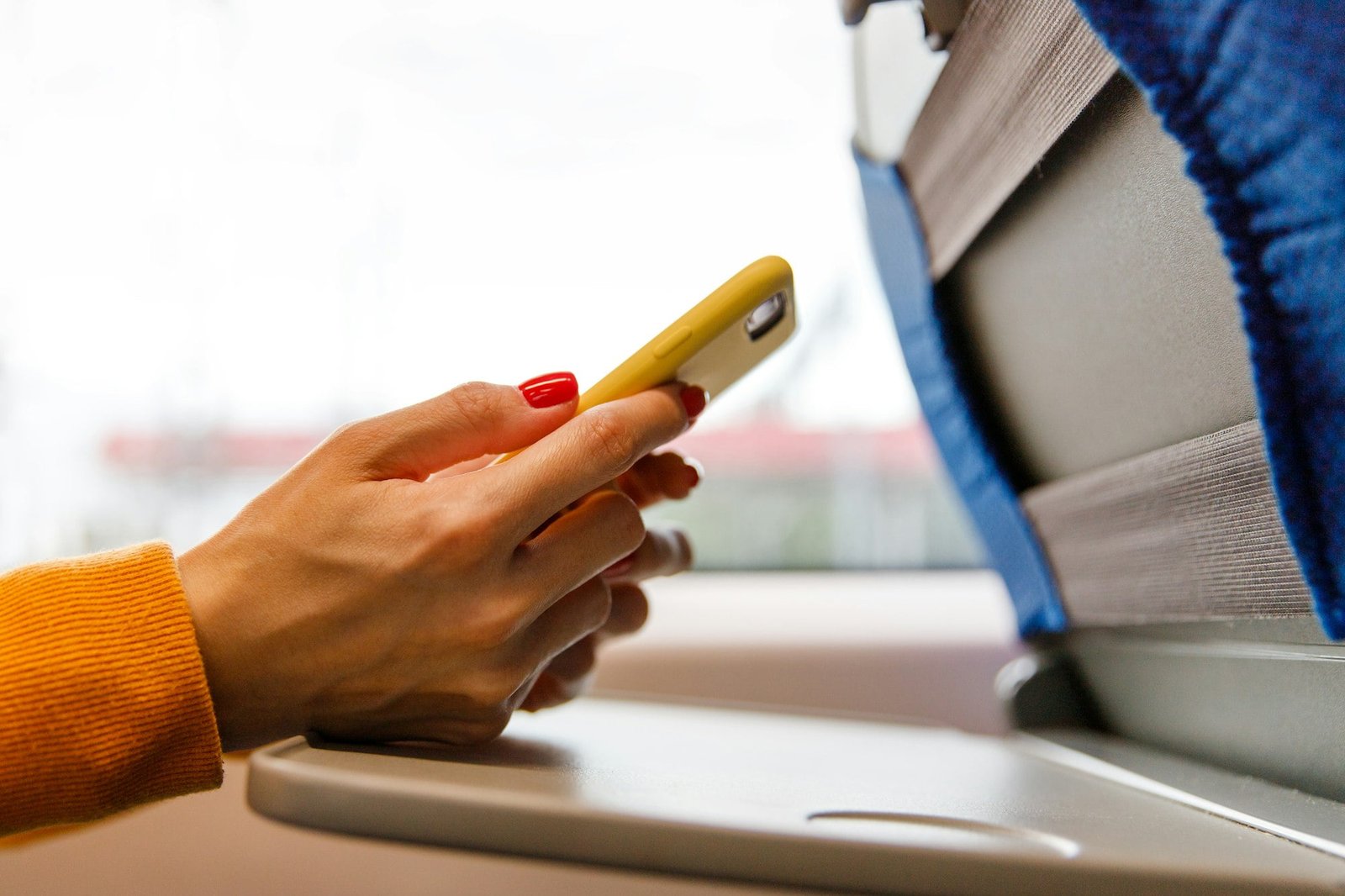 Female using smartphone in public transportation