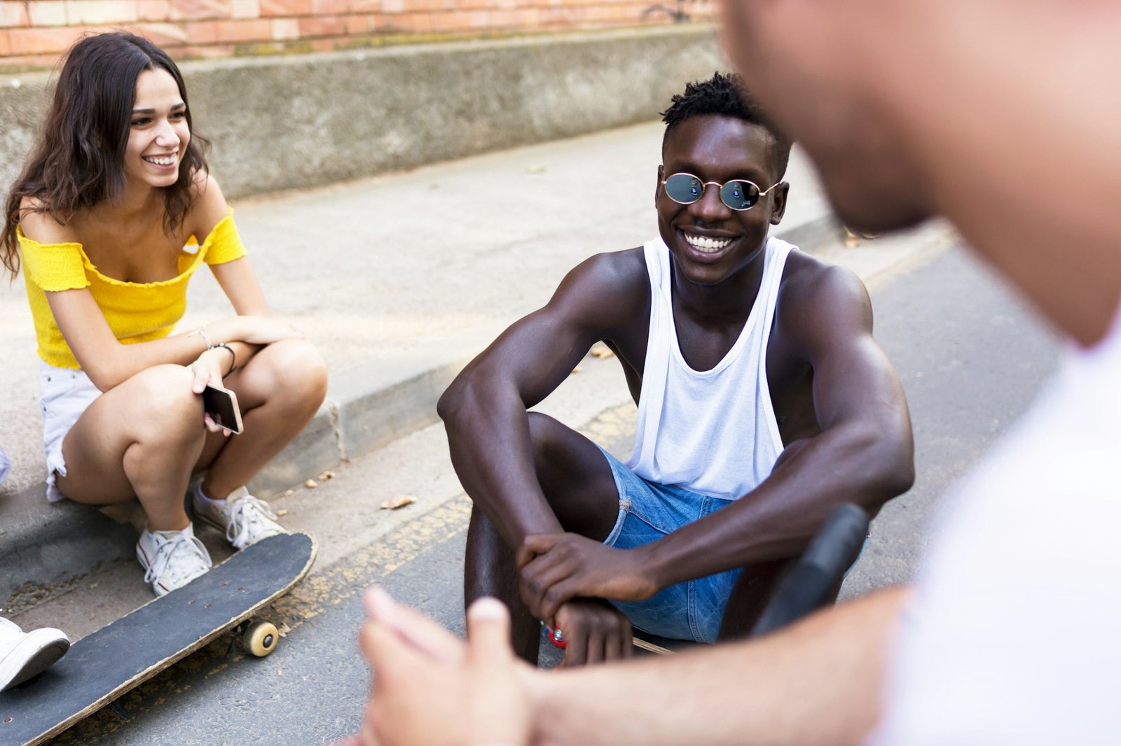 Group of young hipster friends talking in an urban area.