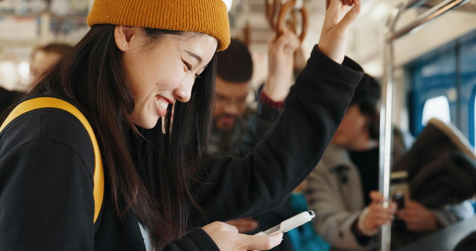 Japan woman, happy and train on smartphone, social media and public transportation on metro bullet.