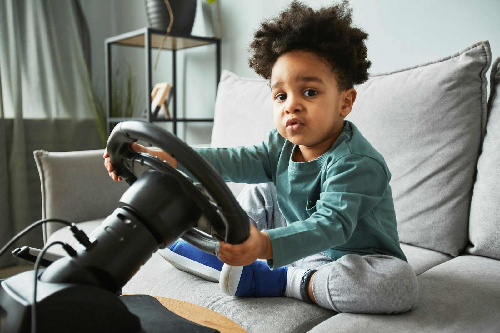 Little Boy Playing with Racing Wheel