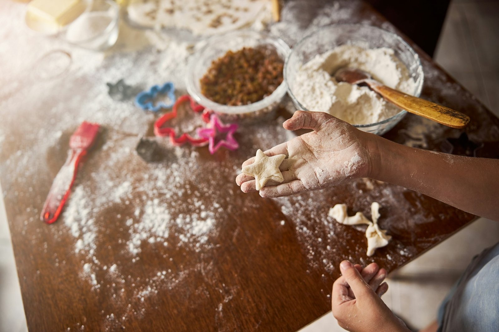 Little chef showing a star-shaped future cookie