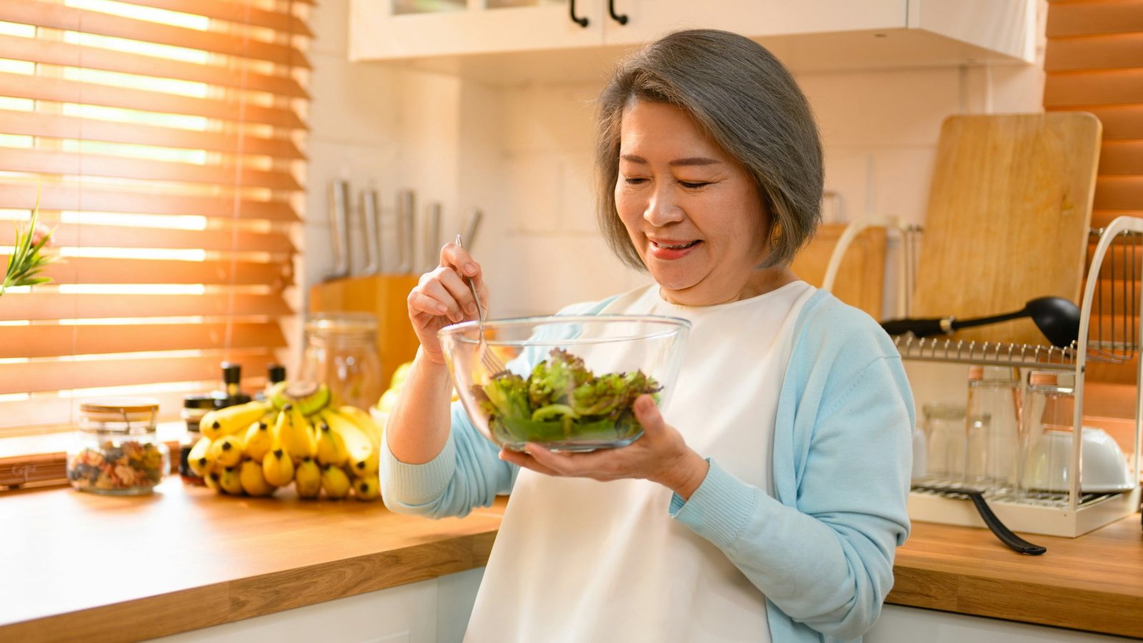 mature and old adult woman takes on the role of a skilled cooking salad.