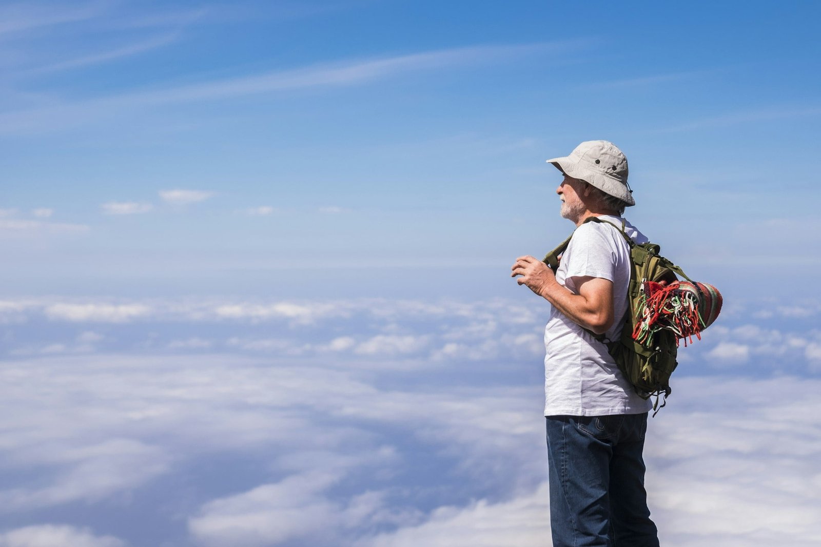 Old silver societ white hair man standing and resting looking the blue sky infinite in front of him