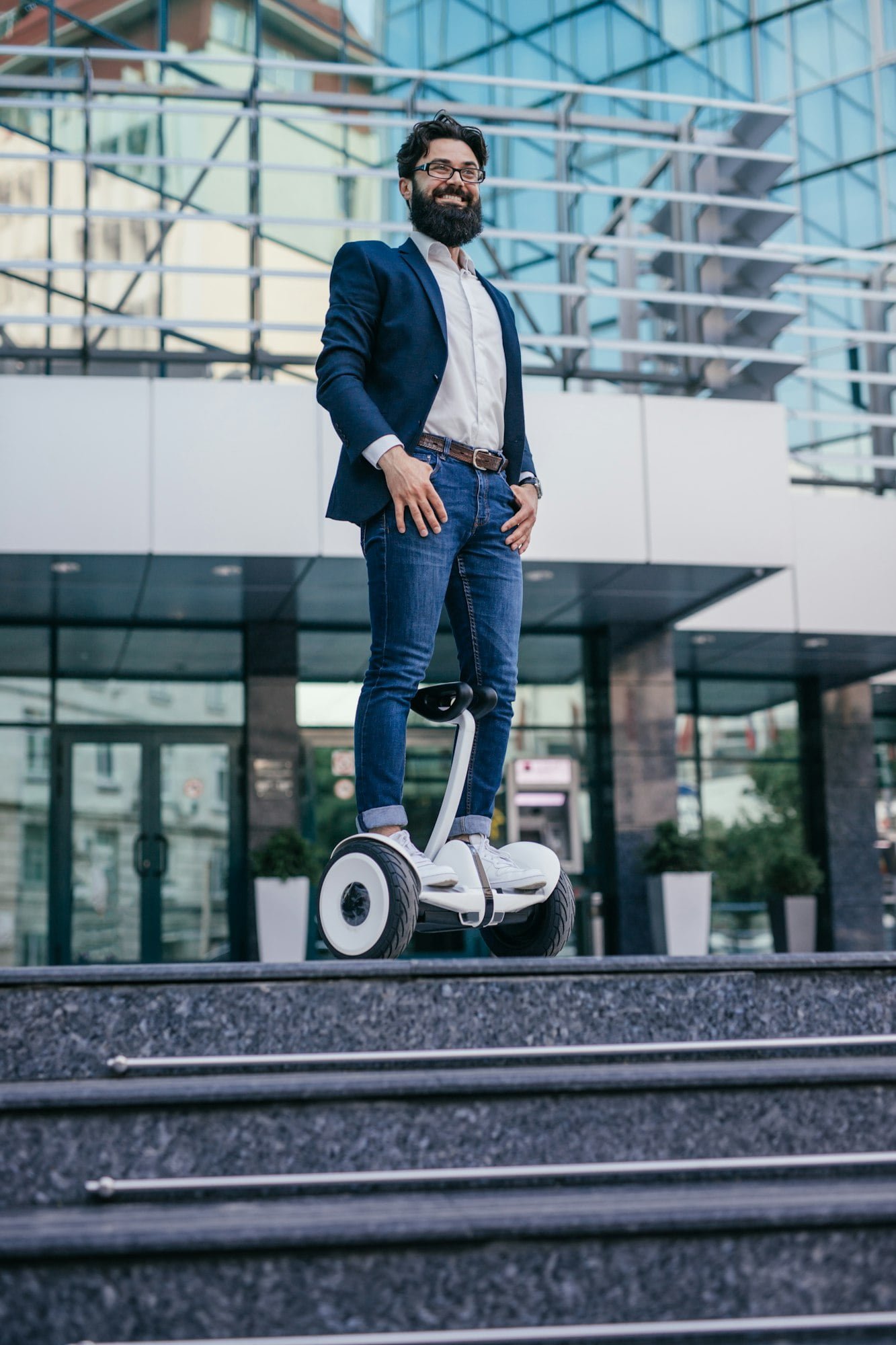 Positive guy standing on electric vehicle