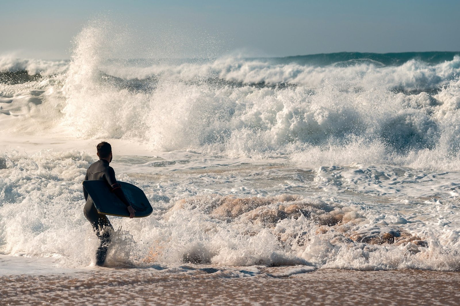 Surfer faces the challenge of a powerful rough sea