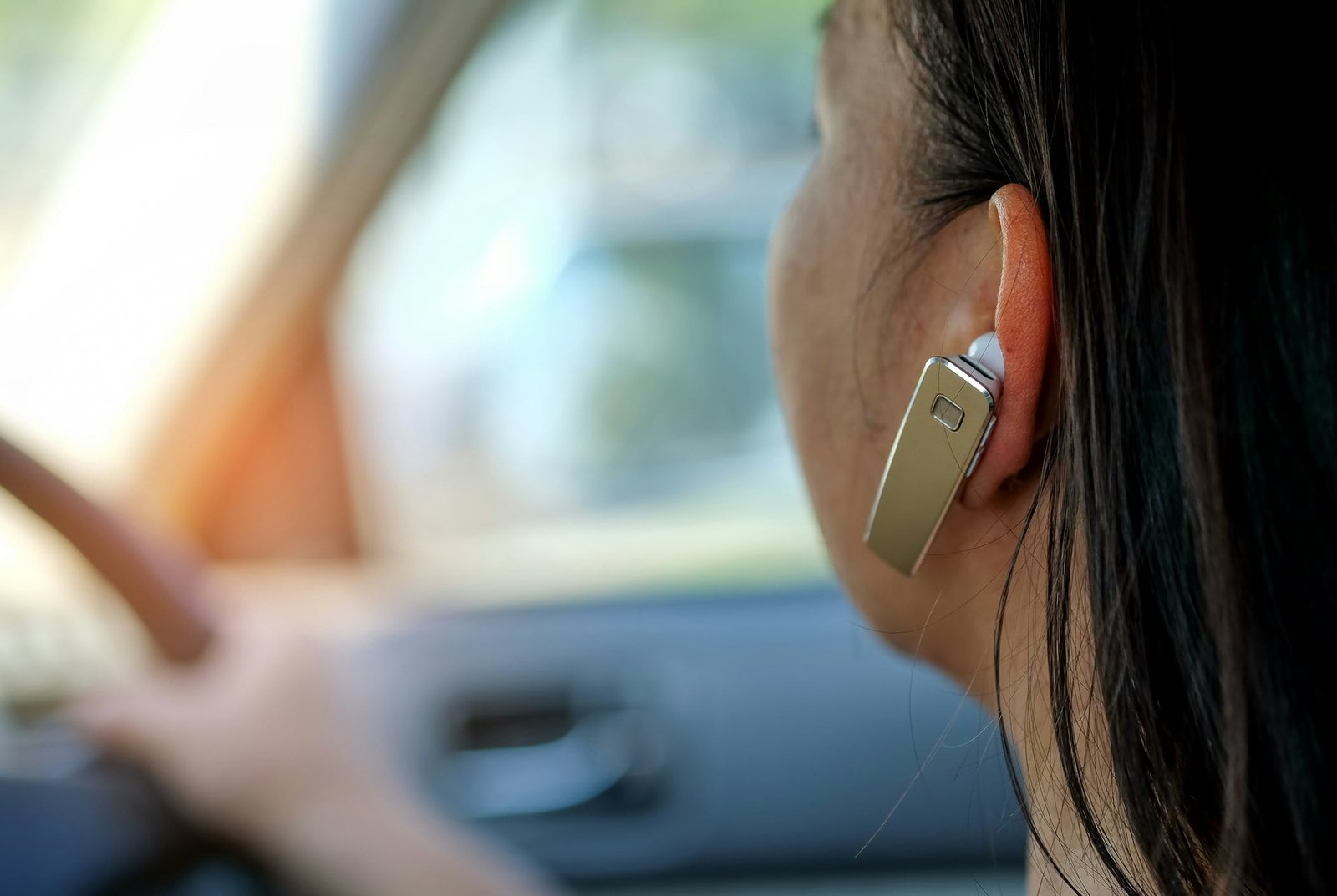 Women using hands-free phone while driving.